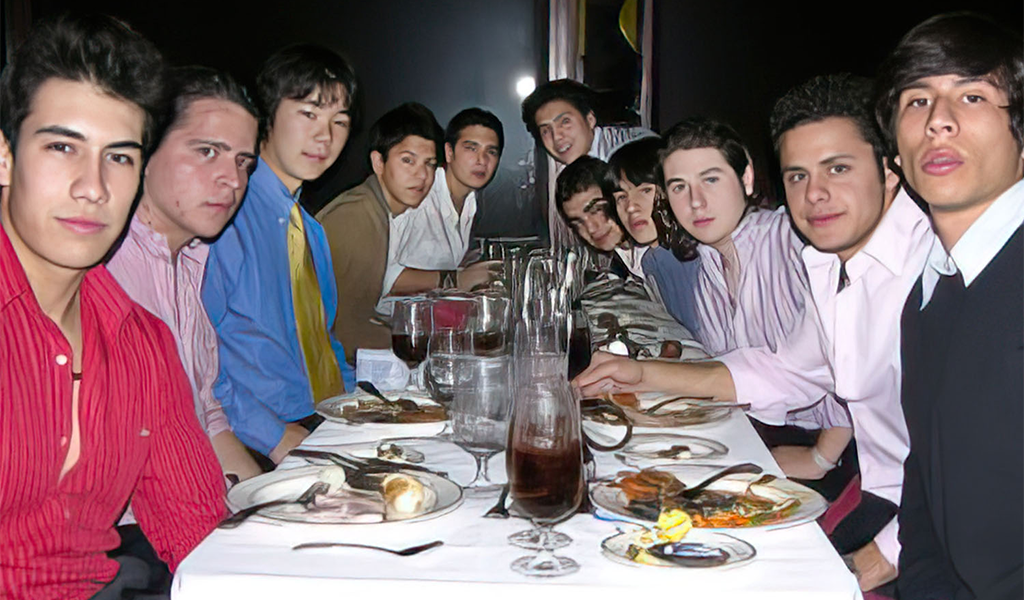 a group of people sitting at a table with food_