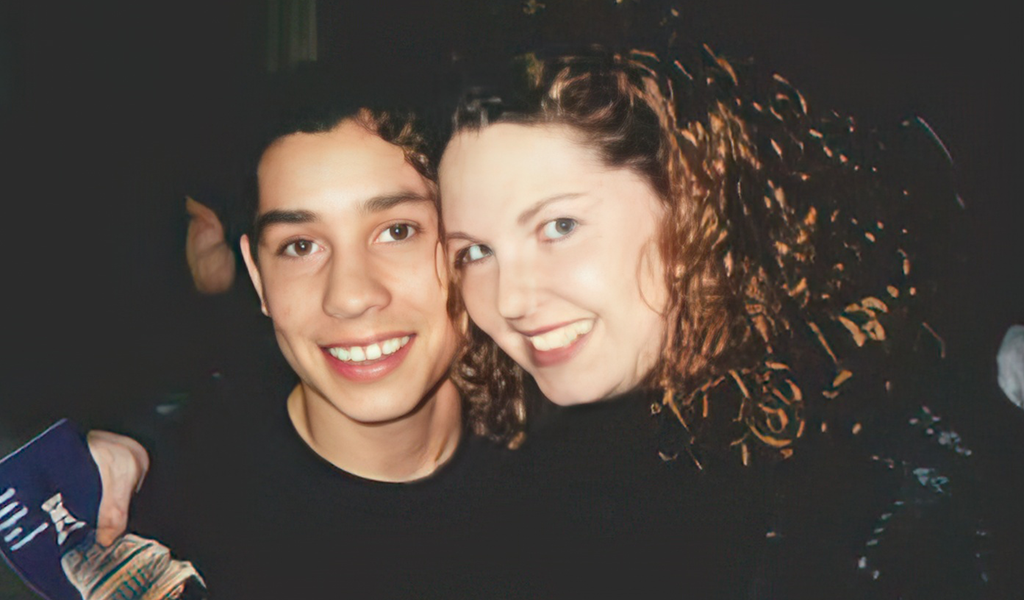 a young man and a woman posing for a picture